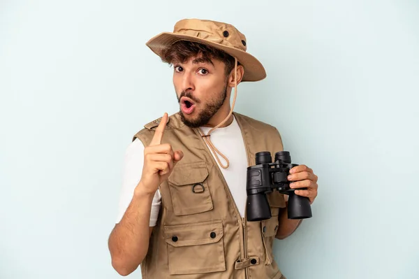Young Mixed Race Man Holding Binoculars Isolated Blue Background Having — 图库照片