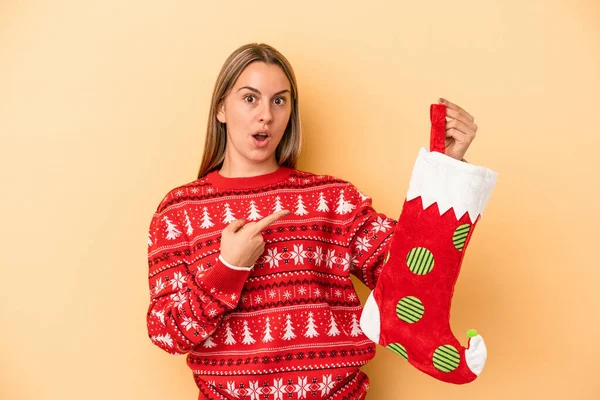 Young Caucasian Woman Holding Elf Sock Isolated Yellow Background Pointing — Stock Photo, Image