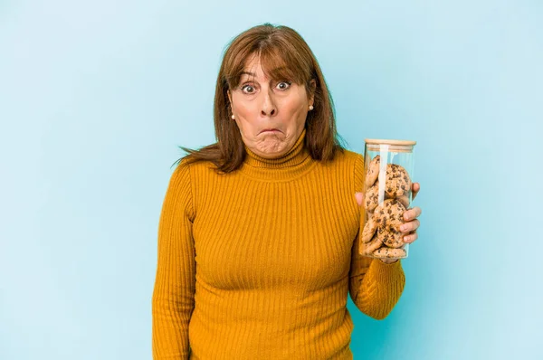 Middle Age Caucasian Woman Holding Cookies Jar Isolated Blue Background — Fotografia de Stock