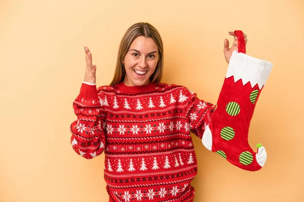 Young Caucasian Woman Holding Elf Sock Isolated Yellow Background Receiving — Stock Photo, Image