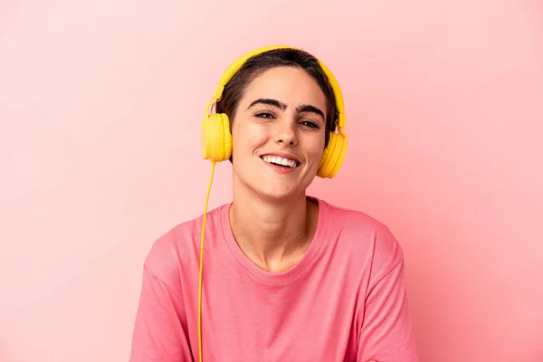 Young Caucasian Woman Listening Music Isolated Pink Background Laughing Having — Stock Photo, Image