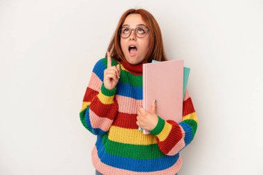 Young student caucasian woman isolated on white background pointing upside with opened mouth.