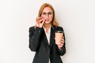 Young business caucasian woman holding take away coffee isolated on white background with fingers on lips keeping a secret.