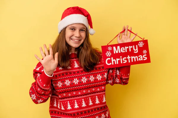 Little Caucasian Girl Holding Merry Christmas Placard Isolated Yellow Background — 스톡 사진
