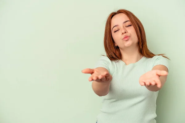 Young Caucasian Woman Isolated Green Background Folding Lips Holding Palms — Stock Photo, Image