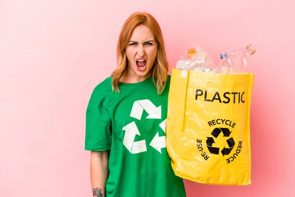 Young Caucasian Woman Recycled Plastic Isolated Pink Background Screaming Very — Stockfoto