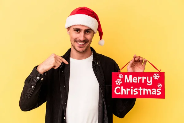Jonge Blanke Man Met Een Vrolijk Kerstbordje Geïsoleerd Gele Achtergrond — Stockfoto