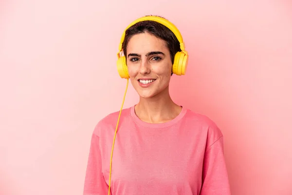 Young Caucasian Woman Listening Music Isolated Pink Background Happy Smiling — Stock Photo, Image