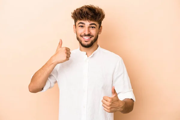 Young Arab Man Isolated Beige Background Raising Both Thumbs Smiling — 图库照片