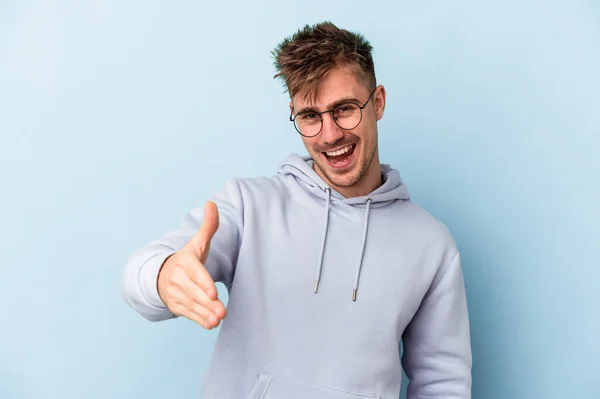 Young Caucasian Man Isolated Blue Background Stretching Hand Camera Greeting — Stock Photo, Image