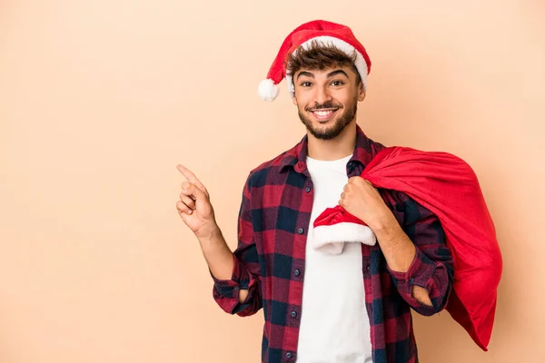 Young Arab Man Disguised Santa Claus Isolated Beige Background Smiling — Foto Stock