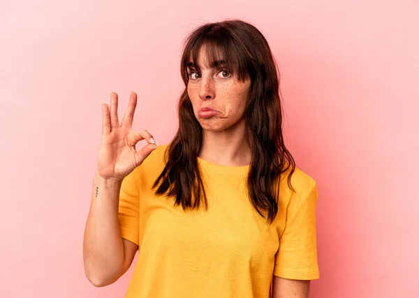 Young Argentinian Woman Isolated Pink Background Winks Eye Holds Okay — Fotografia de Stock