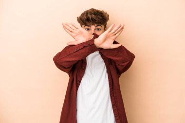 Young arab man isolated on beige background doing a denial gesture