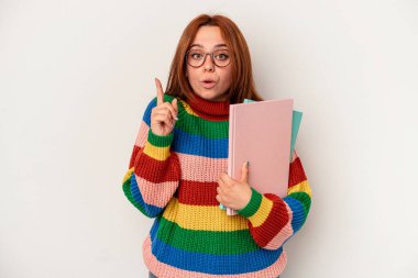 Young student caucasian woman isolated on white background having some great idea, concept of creativity.