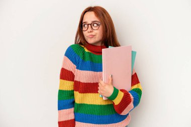 Young student caucasian woman isolated on white background confused, feels doubtful and unsure.
