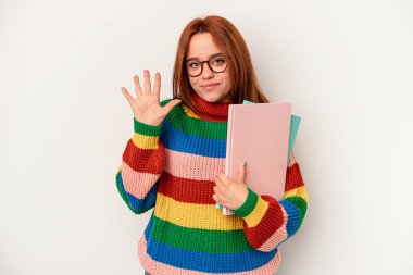 Young student caucasian woman isolated on white background smiling cheerful showing number five with fingers.