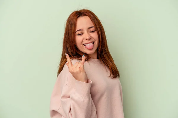 Mujer Joven Caucásica Aislada Sobre Fondo Verde Mostrando Gesto Rocoso — Foto de Stock