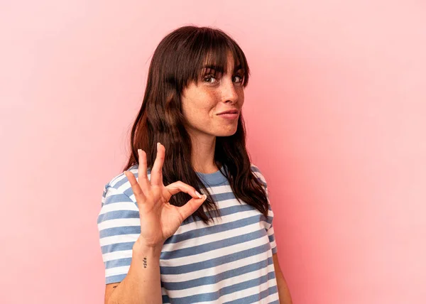 Young Argentinian Woman Isolated Pink Background Winks Eye Holds Okay — 스톡 사진