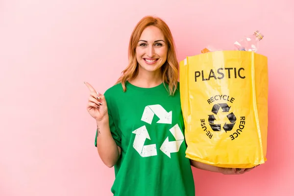 Young Caucasian Woman Recycled Plastic Isolated Pink Background Smiling Pointing — Foto Stock