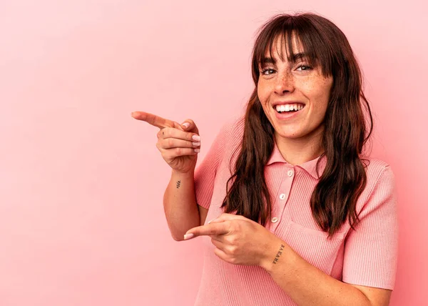Young Argentinian Woman Isolated Pink Background Excited Pointing Forefingers Away — Fotografia de Stock