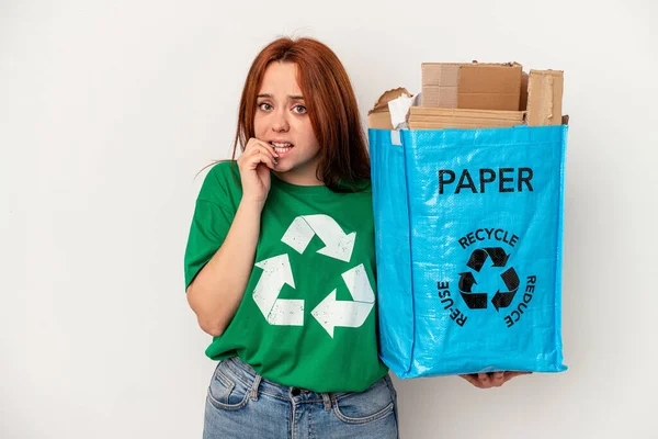 Young Caucasian Woman Recycled Paper Isolated White Background Biting Fingernails — Stok fotoğraf