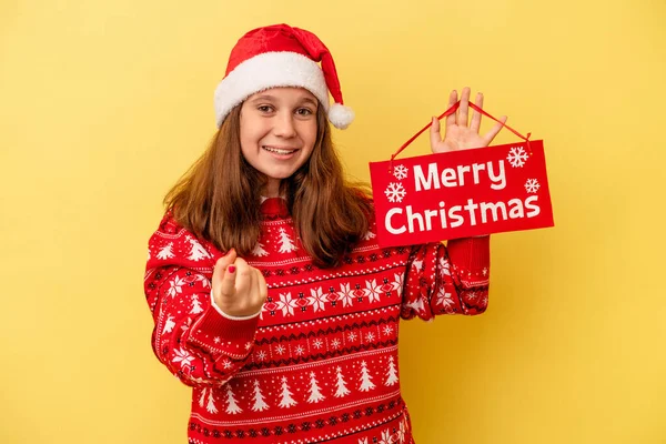 Little Caucasian Girl Holding Merry Christmas Placard Isolated Yellow Background — 스톡 사진