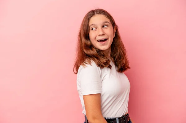 Pequeña Chica Caucásica Aislada Sobre Fondo Rosa Mira Lado Sonriente —  Fotos de Stock
