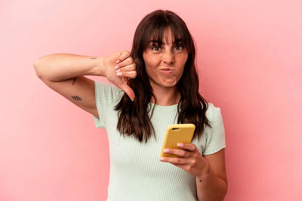 Die Junge Argentinierin Hält Ihr Handy Isoliert Auf Rosa Hintergrund — Stockfoto