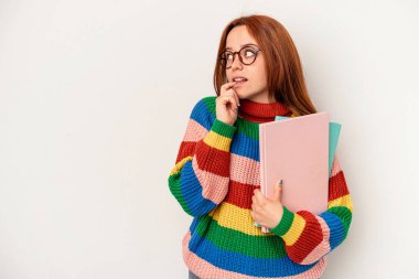 Young student caucasian woman isolated on white background relaxed thinking about something looking at a copy space.