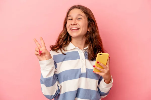 Little Caucasian Girl Holding Mobile Phone Isolated Pink Background Joyful —  Fotos de Stock