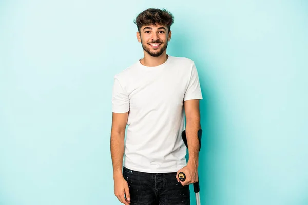 Young Arab Man Crutches Isolated Blue Background Happy Smiling Cheerful — Fotografia de Stock