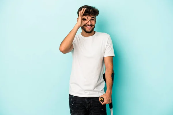 Young Arab Man Crutches Isolated Blue Background Excited Keeping Gesture — Stock Photo, Image