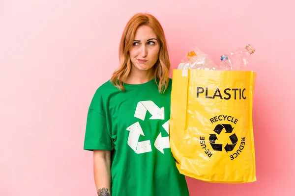 Young Caucasian Woman Recycled Plastic Isolated Pink Background Confused Feels — Foto Stock