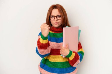 Young student caucasian woman isolated on white background showing fist to camera, aggressive facial expression.
