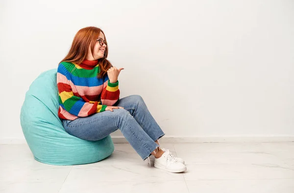 Young Caucasian Woman Sitting Puff Isolated White Background Points Thumb — Fotografia de Stock