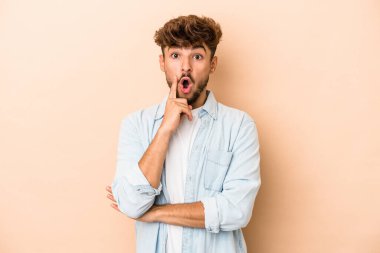 Young arab man isolated on beige background having some great idea, concept of creativity.