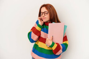 Young student caucasian woman isolated on white background covering ears with hands.