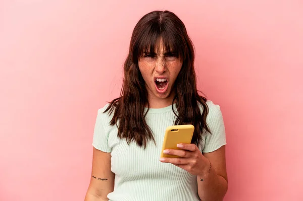 Young Argentinian Woman Holding Mobile Phone Isolated Pink Background Screaming — 스톡 사진