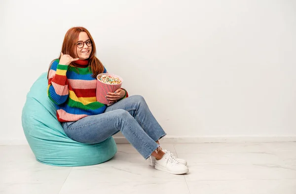 Young Caucasian Woman Sitting Puff Popcorns Isolated White Background Showing — Fotografia de Stock