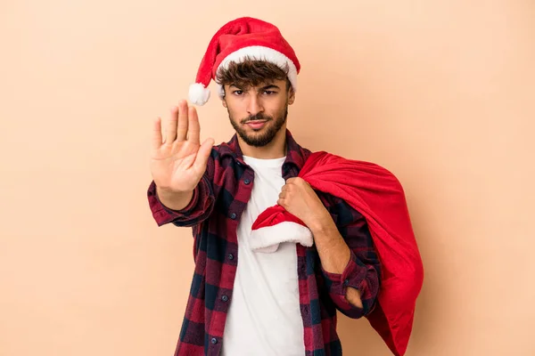 Young Arab Man Disguised Santa Claus Isolated Beige Background Standing — Stockfoto
