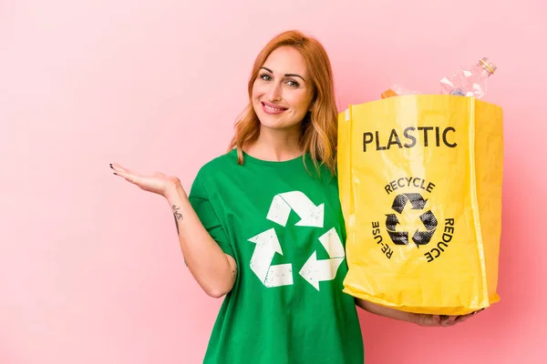 Young Caucasian Woman Recycled Plastic Isolated Pink Background Showing Copy — Stockfoto