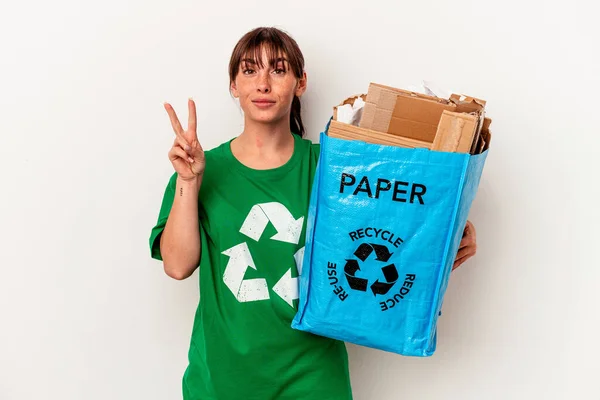 若いアルゼンチンの女性は 指で2番目を示す黄色の背景に隔離された紙をリサイクル — ストック写真