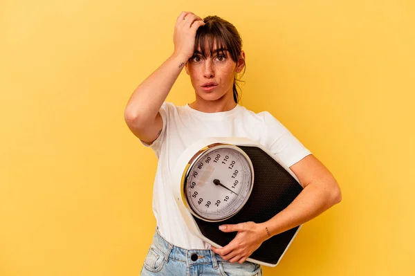 Young Woman Holding Scale Isolated Yellow Background Being Shocked She — Stock Photo, Image