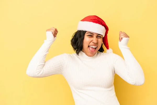 Young Latin Woman Celebrating Christmas Isolated Yellow Background Raising Fist — ストック写真