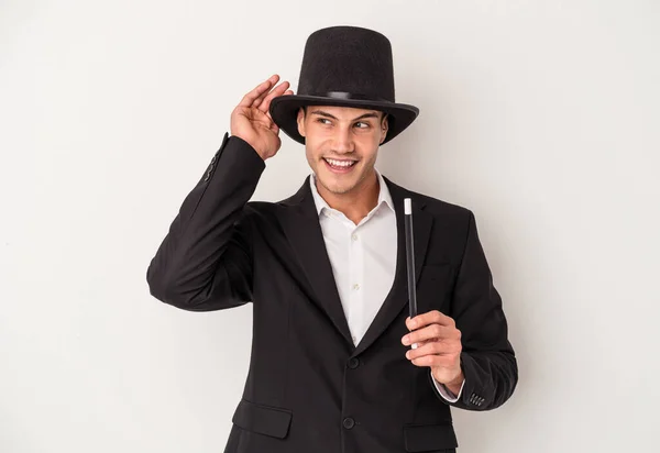 Young Magician Caucasian Man Holding Wand Isolated White Background Trying — Stock Photo, Image