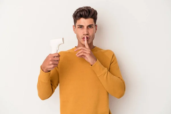 Young Caucasian Man Holding Thermometer Isolated White Background Keeping Secret — Stock Photo, Image