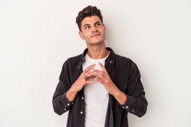 Kafkasyalı genç bir adam beyaz arka planda izole edildi. Aklında bir plan oluşturdu..