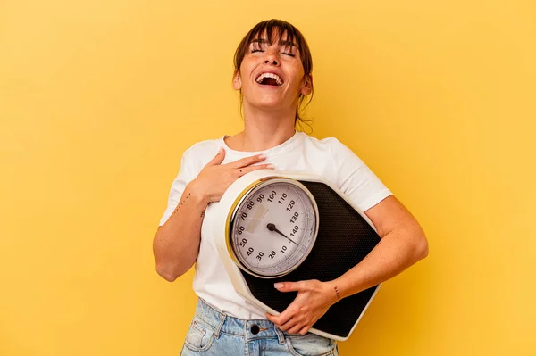 Young Woman Holding Scale Isolated Yellow Background Laughs Out Loudly — Stock Photo, Image