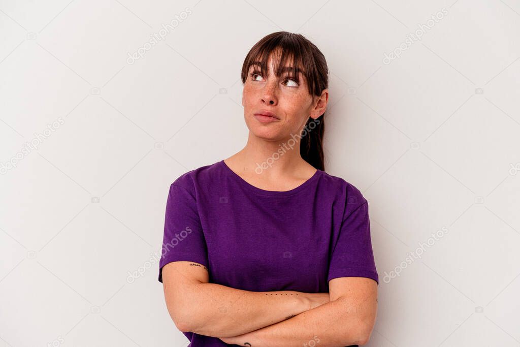 Young Argentinian woman isolated on white background dreaming of achieving goals and purposes