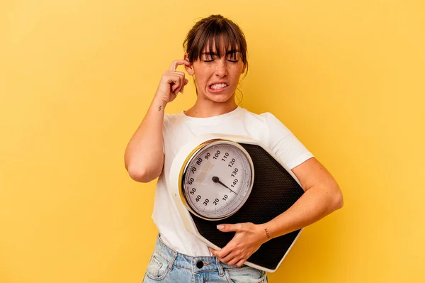 Young Woman Holding Scale Isolated Yellow Background Covering Ears Hands — Stock Photo, Image